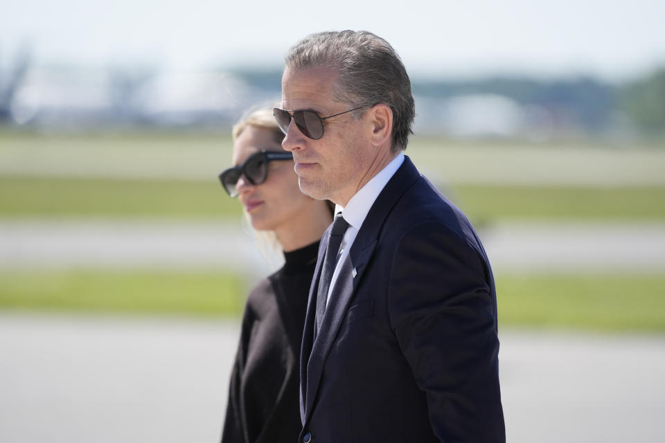 Hunter Biden, President Joe Biden's son, right, walks with his wife Melissa Cohen Biden, to board Air Force One at Dover Air Force Base, Del., Friday, May 31, 2024. President Biden is returning to Washington. (AP Photo/Alex Brandon)