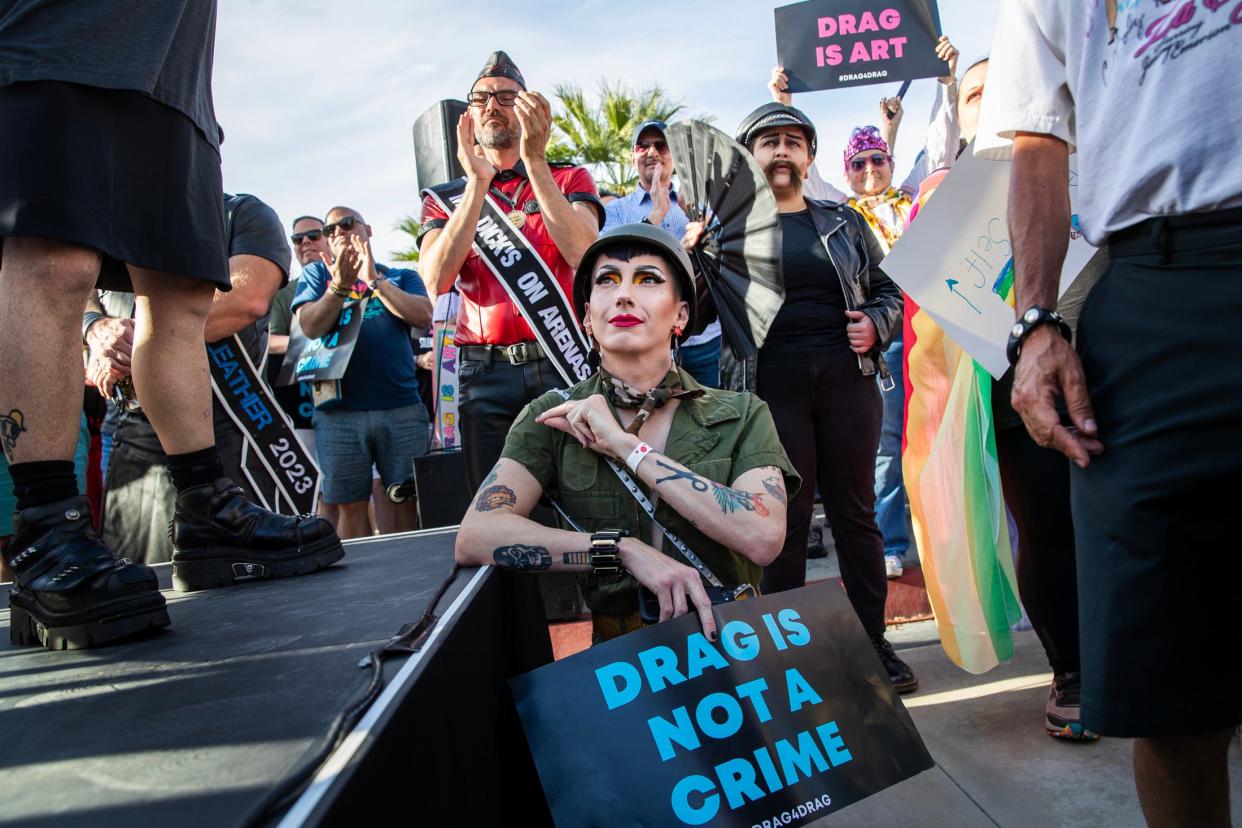 JC Distefano of Palm Springs listens to speakers during the Drag4Drag rally to protest anti-drag legislation around the country in downtown Palm Springs, Calif., on Tuesday, April 18, 2023.