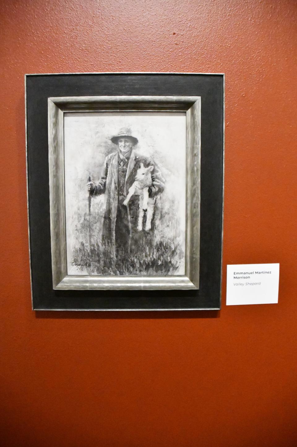 An image by Emanuel Martinez showing a shepherd holding a lamb is part of the Hecho en Colorado exhibit at El Pueblo History Museum in Pueblo, Colo.