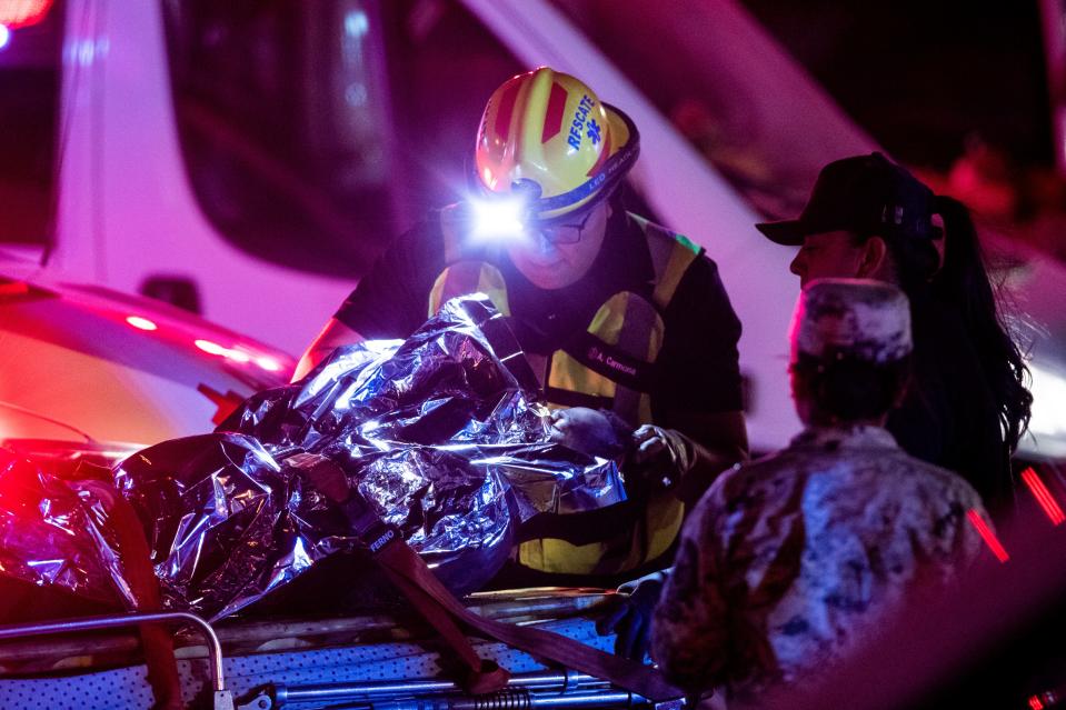 Medics give aid to a migrant who survived a fire that broke out at a Mexican immigration detention center in Juarez on Monday, March 27, 2023.