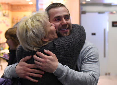 Russian Olympic curler Alexander Krushelnitsky is welcomed upon his return from the Pyeongchang 2018 Winter Olympics, at Pulkovo airport outside St. Petersburg, Russia February 22, 2018. REUTERS/Sergei Nikolaev