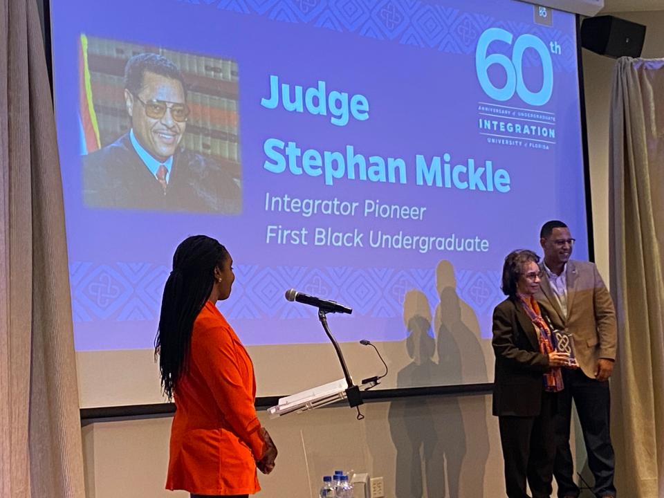 Evelyn Mickle receives an award on behalf of her late husband, Judge Stephen P. Mickle Sr., for being one of the first seven Black students to integrate the University of Florida. Mickle was the first Black student to earn an undergraduate degree at UF and the second Black student to earn a law degree at UF. He later became the first Black federal judge in the U.S. District Court of the Northern District of Florida. He died in 2021 at the age of 76.