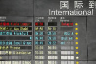 The arrival board at the International Airport in Beijing, China shows a Malaysian airliner is delayed, Saturday, March 8, 2014. A Malaysia Airlines Boeing 777-200 carrying 239 people lost contact with air traffic control early Saturday morning on a flight from Kuala Lumpur to Beijing, and international aviation authorities still hadn't located the jetliner several hours later. (AP Photo/Ng Han Guan)