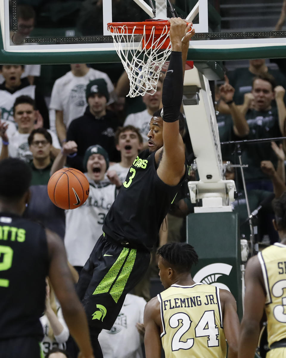 Michigan State forward Xavier Tillman, center, dunks during the first half of an NCAA college basketball game against Charleston Southern, Monday, Nov. 18, 2019, in East Lansing, Mich. (AP Photo/Carlos Osorio)