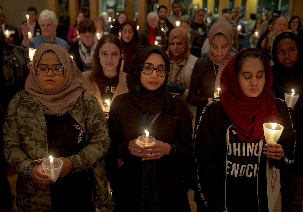 From left: Syeda Sabeera, Sumaiya Syed and Amina Choudhury stand with candles during a prayer service at St. James Episcopal Church on March 16 in Austin, Texas. The service was held in honor of those killed and injured in last Friday's mass shootings at two mosques in Christchurch, New Zealand. (Photo: Nick Wagner/Austin American-Statesman / ASSOCIATED PRESS)