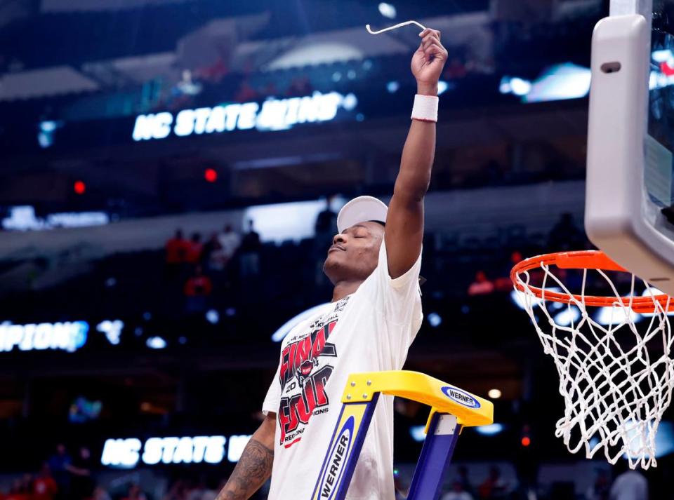 N.C. State’s DJ Horne holds up a piece of the net after N.C. State’s 76-64 victory over Duke in their NCAA Tournament Elite Eight matchup at the American Airlines Center in Dallas, Texas, Sunday, March 31, 2024.