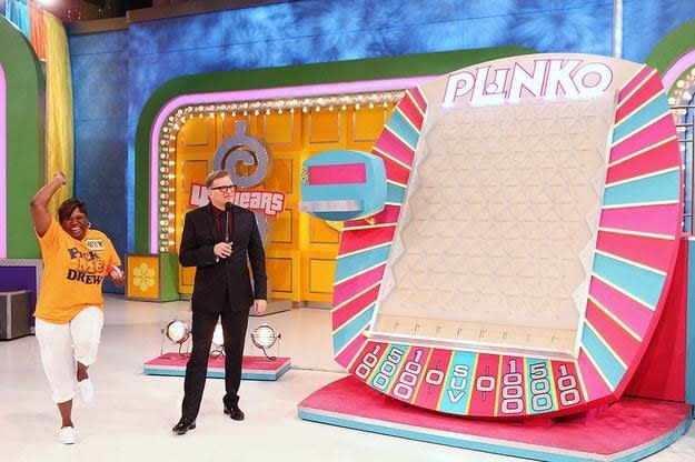A woman dances before playing on the plinko board