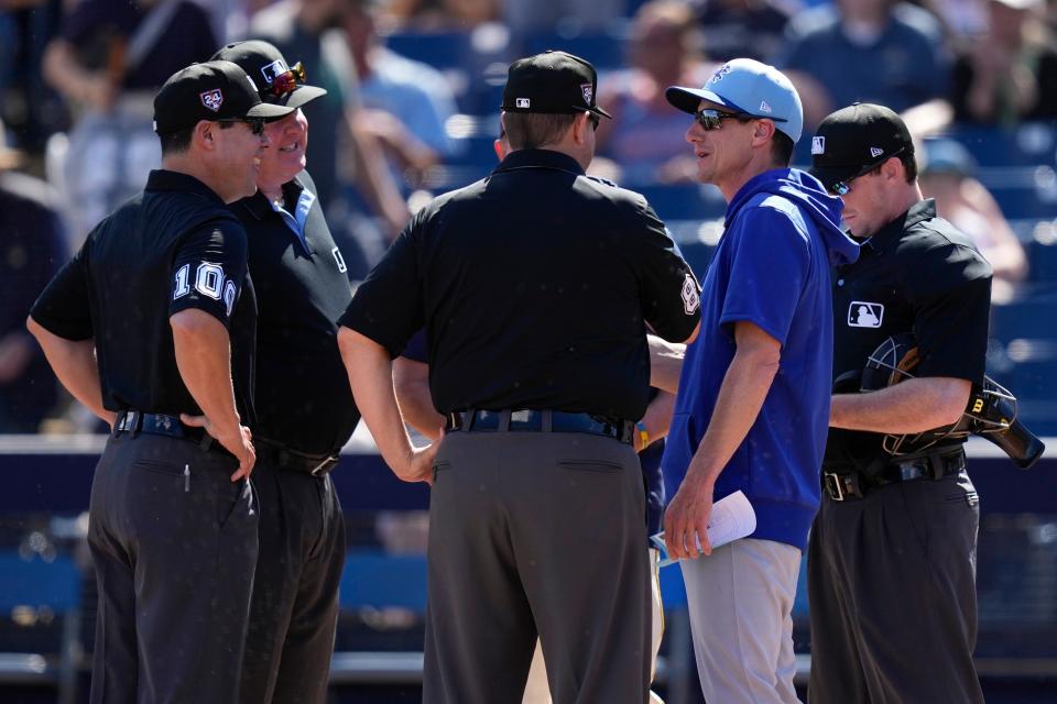 Cubs manager Craig Counsell talks with the umpire crew Wednesday before a game against his former team, the Brewers.