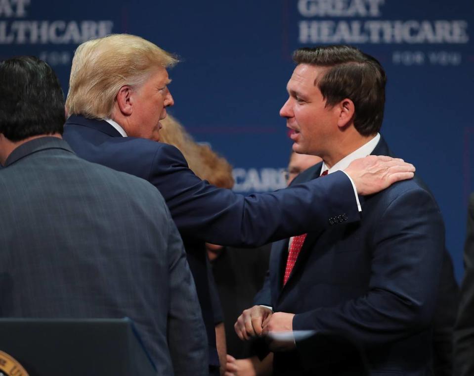 President Donald Trump and Florida Gov. Ron DeSantis talk during an event at The Villages on Oct. 3, 2019.