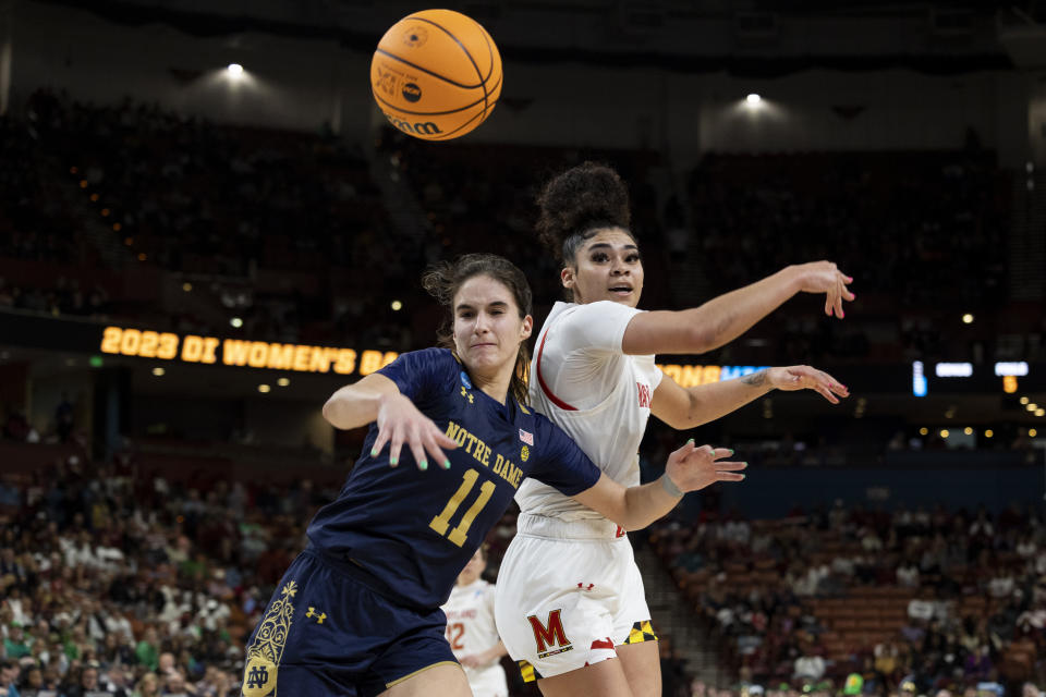 Maryland's Lavender Briggs, right, fights for the ball with Notre Dame's Sonia Citron (11) in the second half of a Sweet 16 college basketball game of the NCAA Tournament in Greenville, S.C., Saturday, March 25, 2023. (AP Photo/Mic Smith)