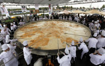 Chefs cook an omelette during a Guinness World Records attempt for the world's largest omelette in Ankara October 8, 2010. The Turkish Egg Producers Association celebrated World Egg Day on Friday with an attempt to cook the world's largest omelette weighing 6 tonnes with a total of 432 litres of oil and 110,000 eggs used. The current record holder for the largest omelette was one made in Cape Town, Western Cape, South Africa, on 9 October 2009 weighing 3.625 tonnes, according to the Guinness World Records website. REUTERS/Umit Bektas