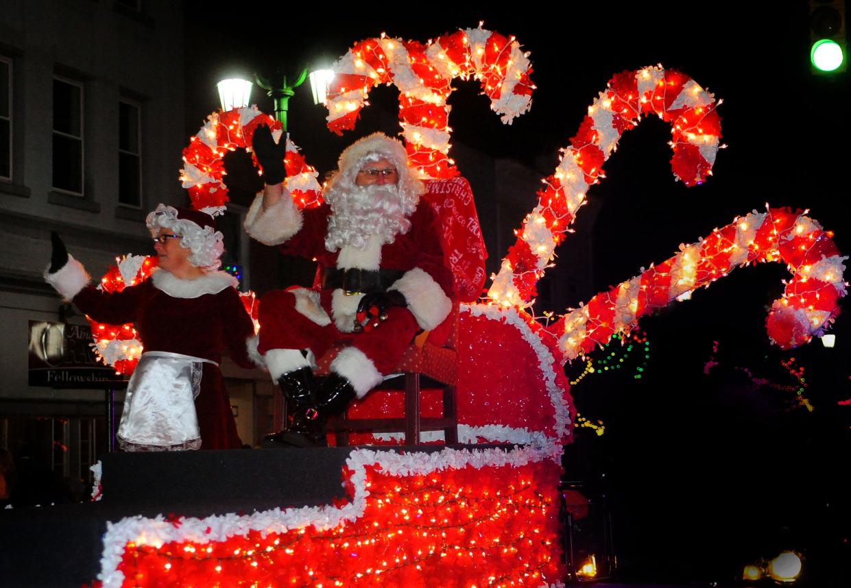 Santa and Mrs. Claus wave to the crowd Saturday, Dec. 3, 2022, during the annual Christmas Parade in downtown Sebring Village.