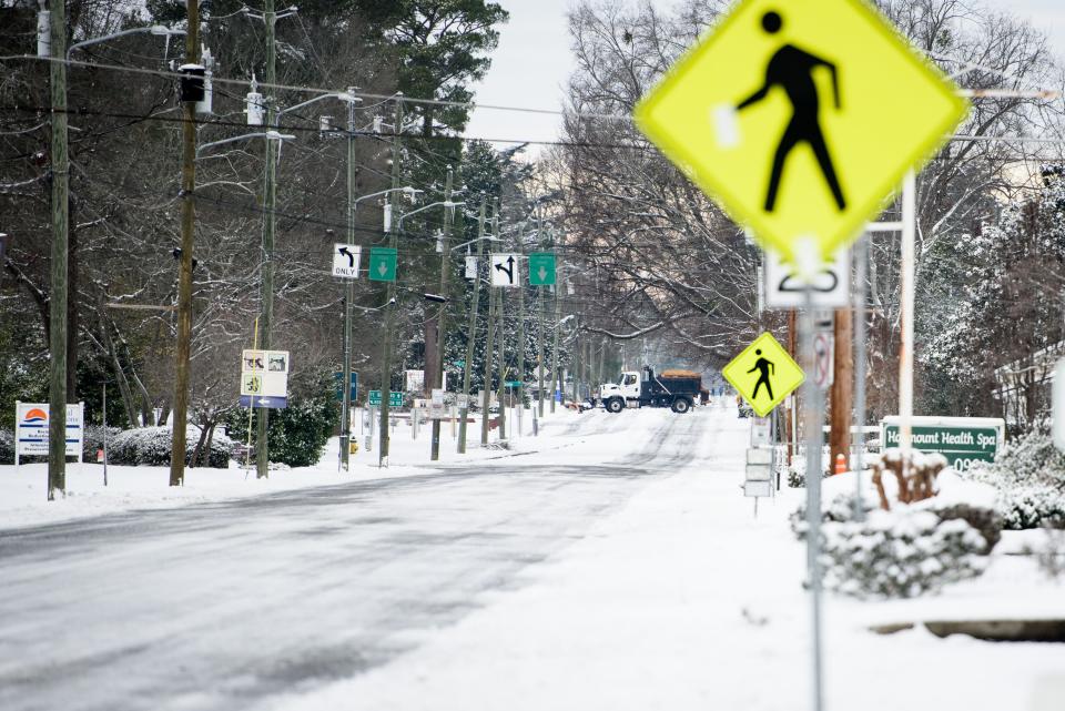 A snowplow clears snow on Fort Bragg Road in Fayetteville on Saturday, Jan. 22, 2022.