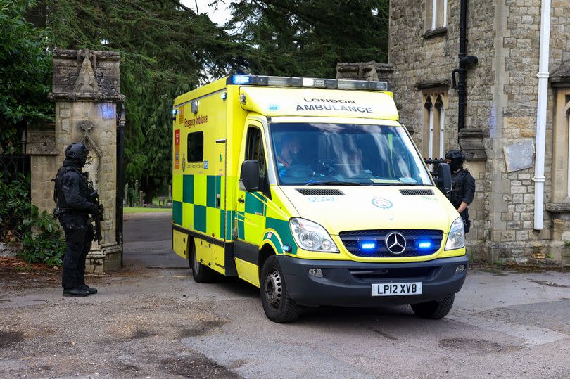 An ambulance leaving the scene at Lavender Hill Cemetery