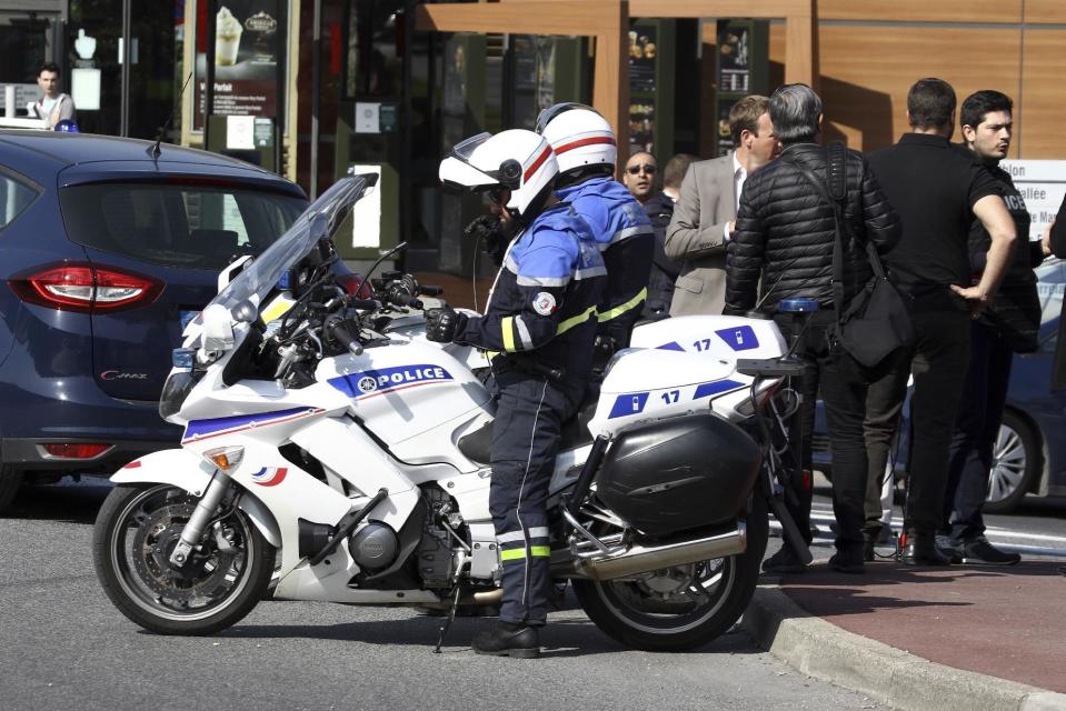 Police officers take position after an attack in a high school in Grasse, southern France, Thursday, March 16, 2017. An armed high school student was arrested and police fanned out around a picturesque perfume capital in southern France after a school shooting that left at least two wounded. (AP Photo/Philippe Farjon)