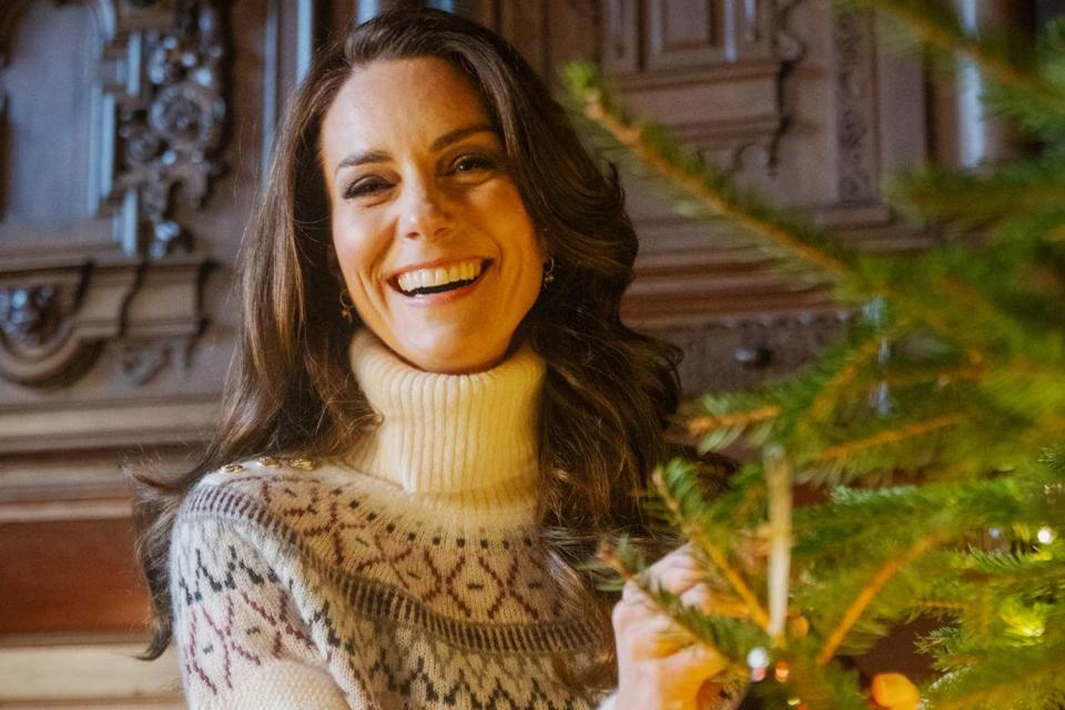 <p>Kensington Palace via Getty</p> Kate Middleton decorates a Christmas tree