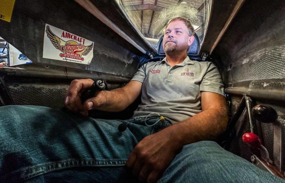 Race pilot Josh Watson demonstrates how he fits inside one of his racing planes in his Wilton hanger on Wednesday, Sept. 6, 2023. Watson and his wife will compete in the last Reno Air Races, which start on Sept. 13. What does he think about during a race? “Lessening the amount that you move, flying smooth, a consistent line and not bumping into anybody,” he said.