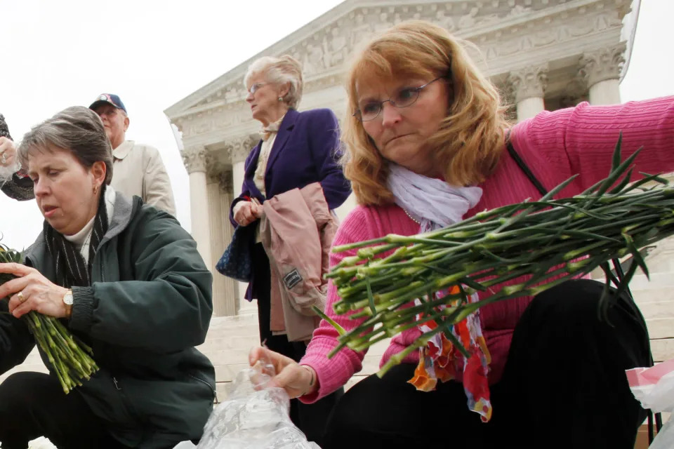 Peggy Nienaber, right, at an event outside the Supreme Court led by Christian faith organizations on the eve of the Supreme Court arguments on President Obama’s health care legislation in 2012. - Credit: Jacquelyn Martin/AP Images