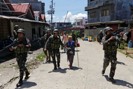 Filipino 62-year-old woman Linda is rescue by soldiers from the combat zone where she and her family were trapped more than 5 weeks in Marawi city, Philippines July 1, 2017. REUTERS/Jorge Silva