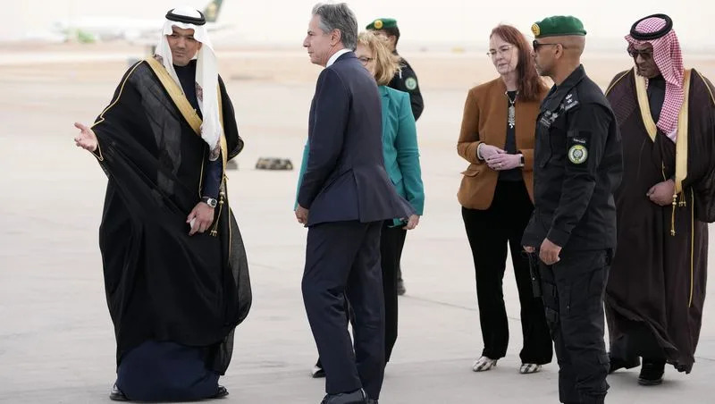 U.S. Secretary of State Antony Blinken, second from left, is welcomed upon his arrival at King Khalid International Airport, in Riyadh, Saudi Arabia, Monday, Feb. 5, 2024. Partially seen third from left is Barbara Leaf, Assistant Secretary of State for Near Eastern Affairs, and Alison Dilworth, Deputy Chief of Mission, third from right.