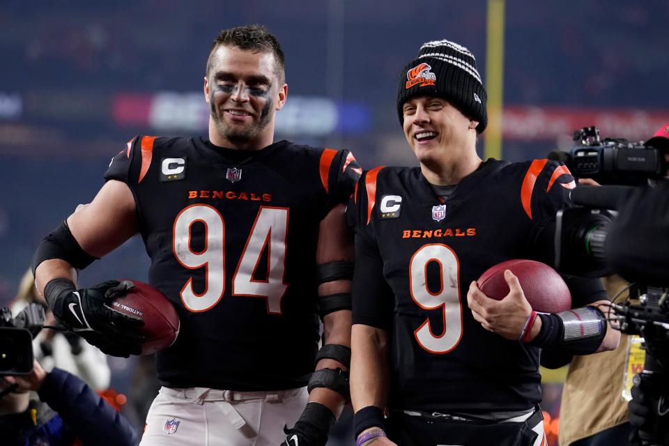 Cincinnati Bengals defensive end Sam Hubbard (94) and quarterback Joe Burrow celebrate following an NFL wild-card playoff football game against the Baltimore Ravens in Cincinnati, Sunday, Jan. 15, 2023. The Bengals won 24-17. (AP Photo/Jeff Dean)