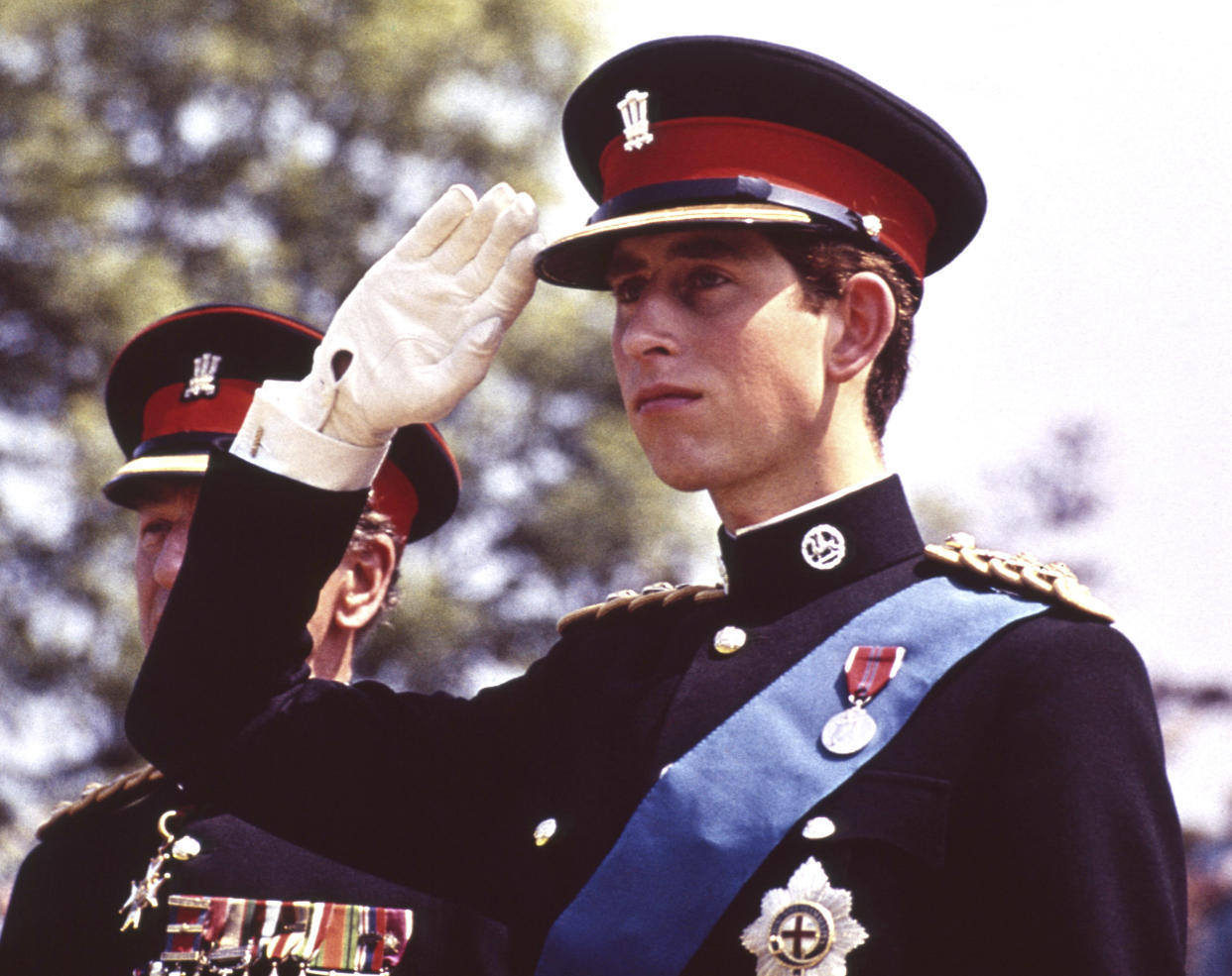 Britain's then-Prince Charles, the Prince of Wales, in the uniform of the Colonel in Chief of the Royal Regiment of Wales, salutes, at the Regiment's Colour presentation, at Cardiff Castle in Wales, June 11, 1969. (AP Photo)