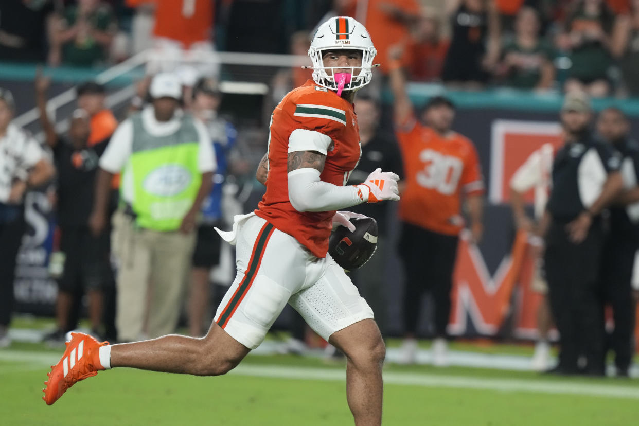 Miami tight end Elijah Arroyo (8) runs for a touchdown during the first half of an NCAA college football game against Virginia Tech , Friday, Sept. 27, 2024, in Miami Gardens, Fla. (AP Photo/Marta Lavandier)