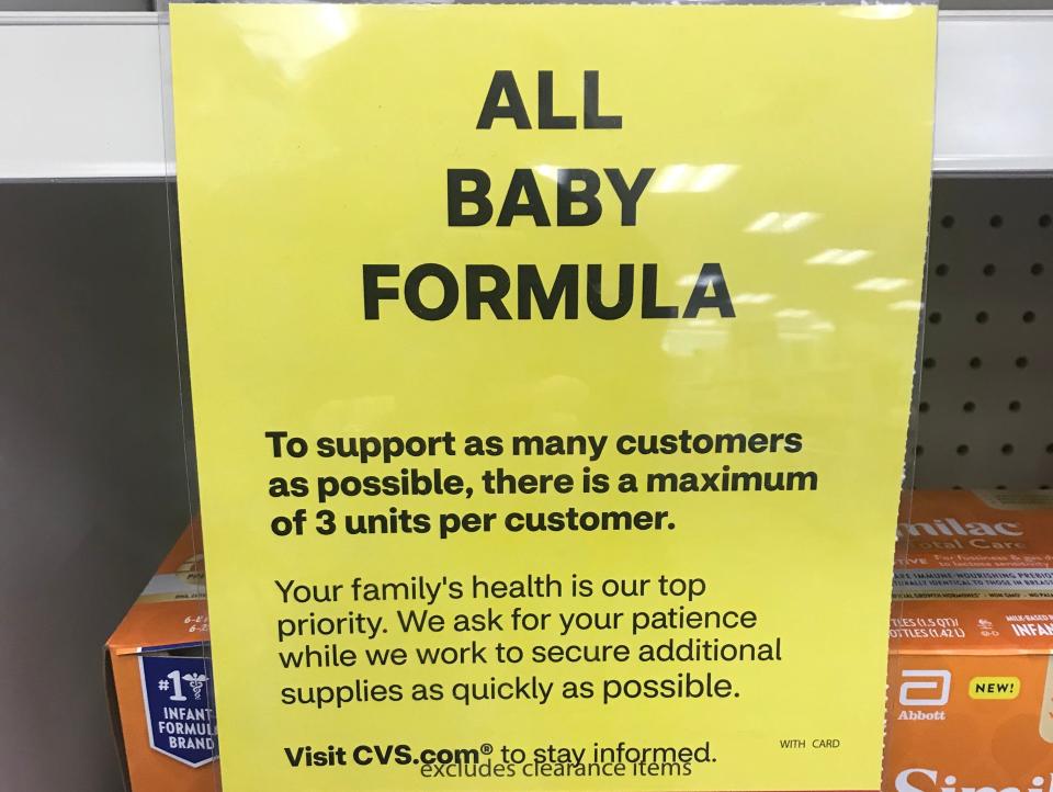 A sign attached to nearly bare shelves at drugstore chain CVS says customers are limited to three containers at a time.