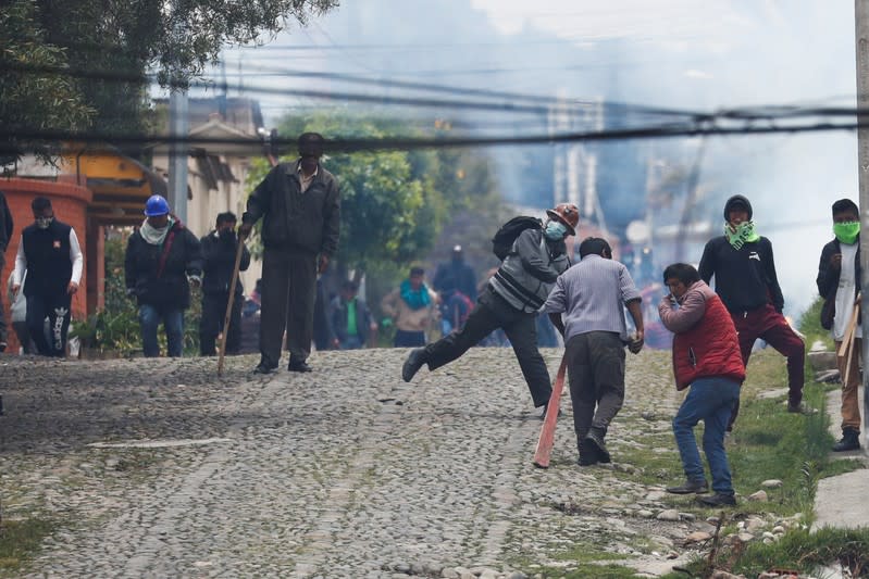 Supporters of Bolivian President Evo Morales and opposition supporters clash during a protest after Morales announced his resignation on Sunday, in La Paz