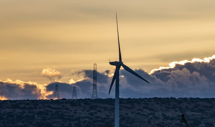 ROSAMOND, CA - FEBRUARY 16, 2021: Dusk settles over wind turbines in the desert landscape near the Tehachapi Mountains on February 16, 2021 in Rosamond, California. Federal wildlife officials are allowing Manzana, a private wind company, to provide funding to rear critically endangered California condors to replace any killed by its turbines. Condors fly through this area at the Tehachapi Mountains as a corridor to the Sierra Nevada range.(Gina Ferazzi / Los Angeles Times)