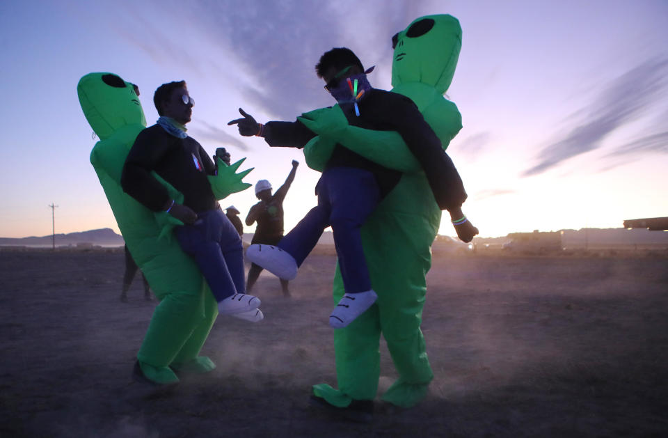 Men dressed as aliens dance at 