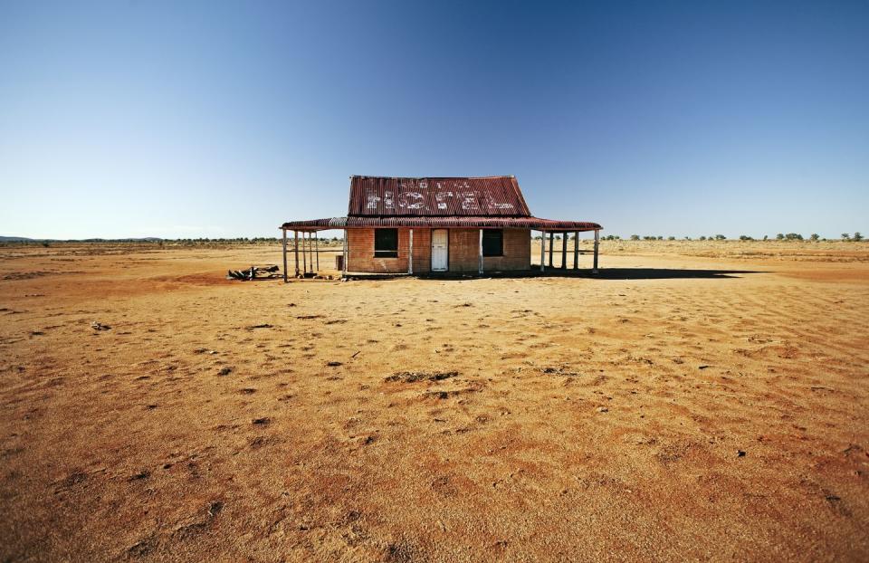 <p>An abandoned house sits in the middle of the desert.</p>