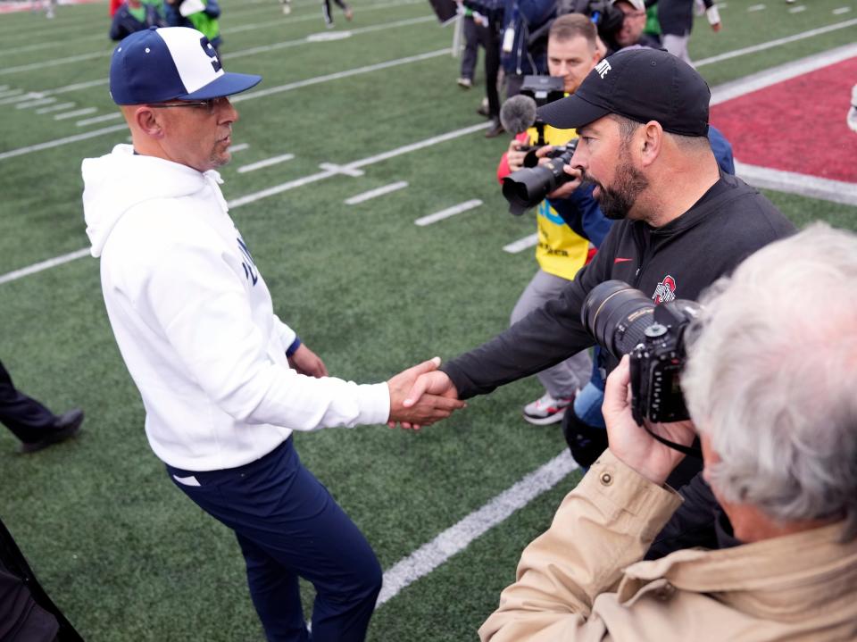 Coaches James Franklin of Penn State and Ryan Day of Ohio State meet after Saturday's game.