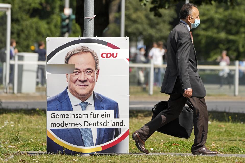 An election poster for the German Christian Democrats, CDU, shows top candidate Armin Laschet at a street in Duesseldorf, Germany, Wednesday, Aug. 25, 2021. A large chunk of the German electorate remains undecided going into an election that will determine who succeeds Angela Merkel as chancellor after 16 years in power. Recent surveys show that support for German political parties has flattened out, with none forecast to receive more than a quarter of the vote. (AP Photo/Martin Meissner)