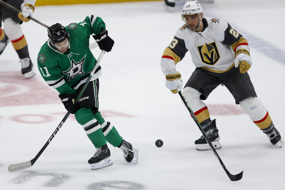 Dallas Stars center Logan Stankoven (11) skates against Vegas Golden Knights defenseman Alec Martinez (23) during the first period in Game 7 of an NHL hockey Stanley Cup first-round playoff series, Sunday, May 5, 2024, in Dallas. (AP Photo/Brandon Wade)