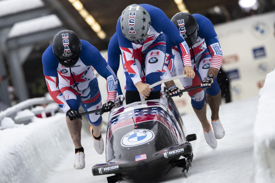 Hunter Church from the United States and his team at the start of the men's four-man bobsleigh World Cup race in Igls, near Innsbruck, Austria, Sunday, Nov. 28, 2021. (AP Photo/Lisa Leutner)