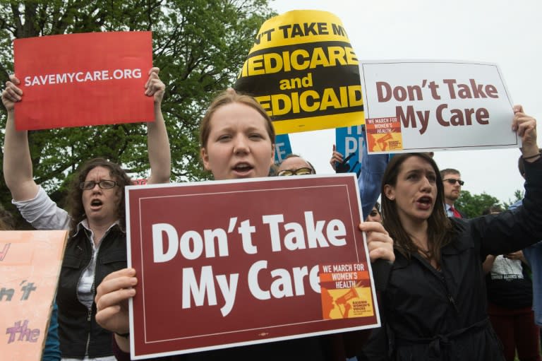 Protesters shout at lawmakers walking out of the US Capitol in Washington, DC, after the House of Representatives narrowly passed a Republican effort to repeal Obamacare