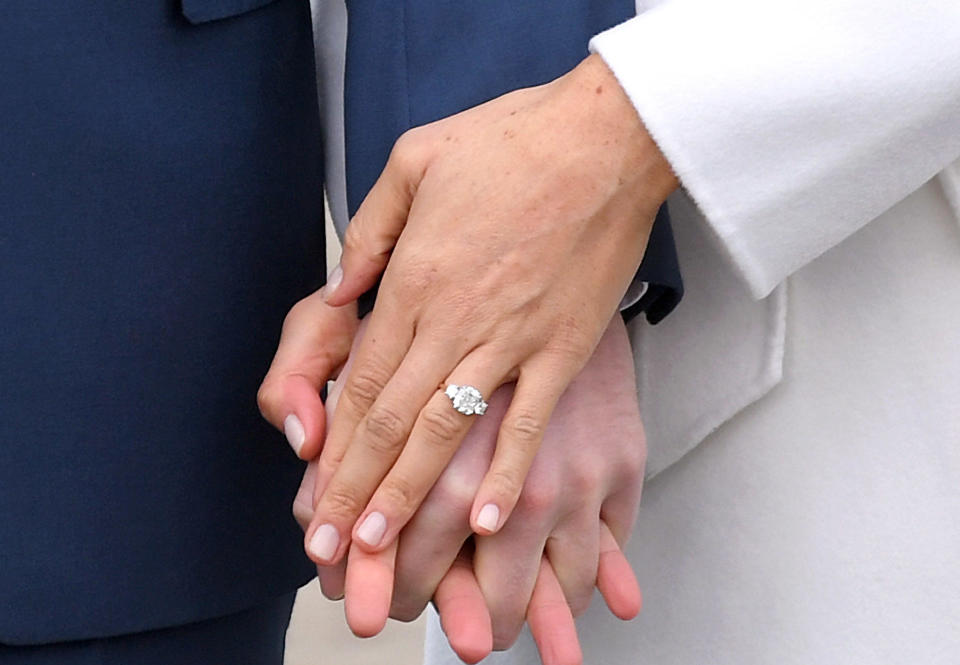 Prince Harry and Meghan Markle hold hands at a photocall to announce their engagement at Kensington Palace in London on Nov. 27, 2017  / Credit: Photo by Karwai Tang/WireImage