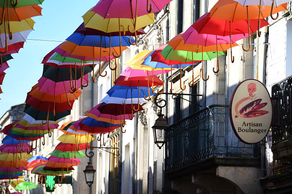 Colourful umbrellas hang above the main street as part of a summer art installation to brighten the town for locals and visitors on June 25, 2018 in Sainte-Foy-La-Grande, France. The town lies 80km west from Bordeaux in South West France and is on the famous River Dordogne where thousands of visitors enjoy the summer months each year. (Photo by James D. Morgan/Getty Images)