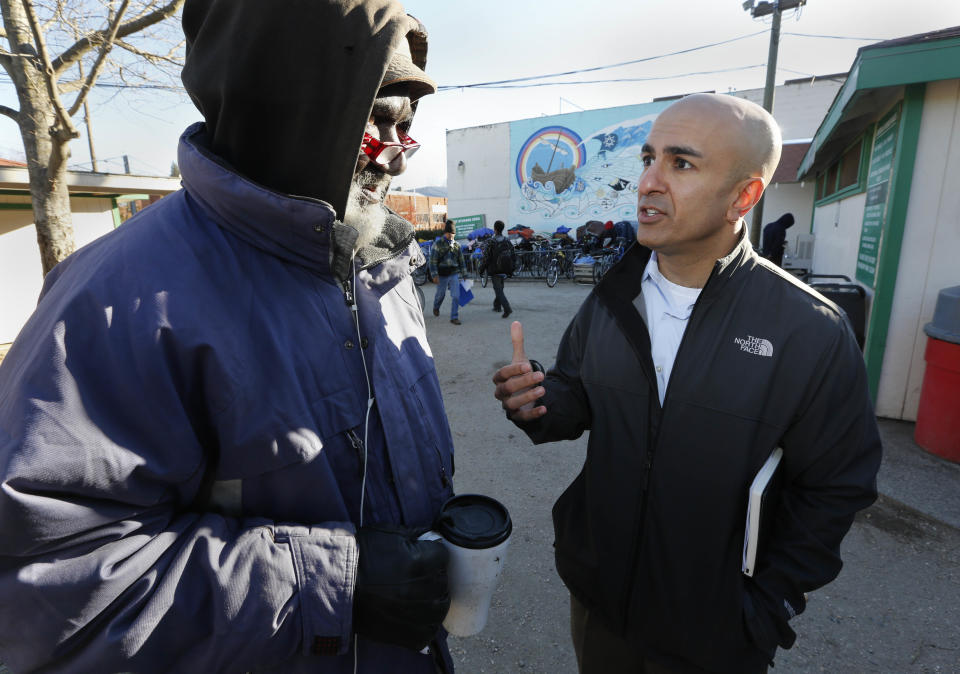 FILE - In this Dec. 4, 2013, file photo, Republican businessman Neel Kashkari, right, talks with Kenneth Whitaker, 62, at the Loaves and Fishes homeless shelter in Sacramento, Calif. Kashkari and Republican Assemblyman Tim Donnelly are challenging Gov. Jerry Brown in his bid to win reelection. (AP Photo/Rich Pedroncelli, File)