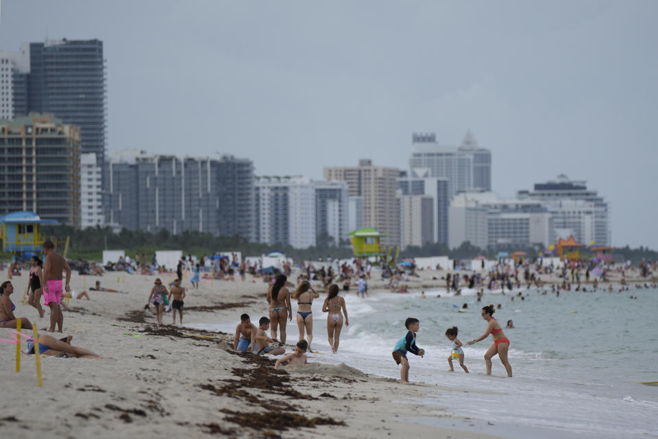 Residents and tourists enjoy South Beach, Friday, July 28, 2023, in Miami Beach, Fla. Humans naturally look to water for a chance to refresh, but when water temperatures get too high, some of the appeal is lost. (AP Photo/Rebecca Blackwell)