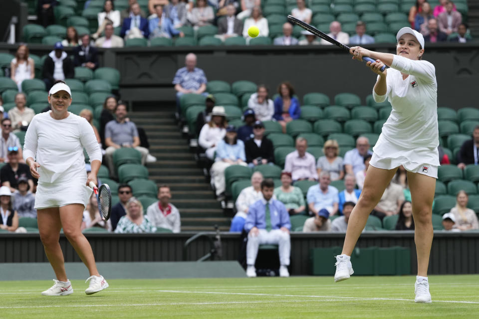 Australia's Ash Barty plays a backhand return during her invitation doubles match with compatriot Casey Dellacqua against Andrea Petkovic of Germany and Magdelena Rybarikova of Slovakia at the Wimbledon tennis championships in London, Wednesday, July 10, 2024. (AP Photo/Kirsty Wigglesworth)