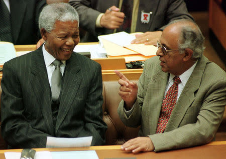 FILE PHOTO: President Nelson Mandela talks to fellow veteran politician Ahmed Kathrada before Mandela's address to Parliament in Cape Town March 2, 1999. REUTERS/File Photo