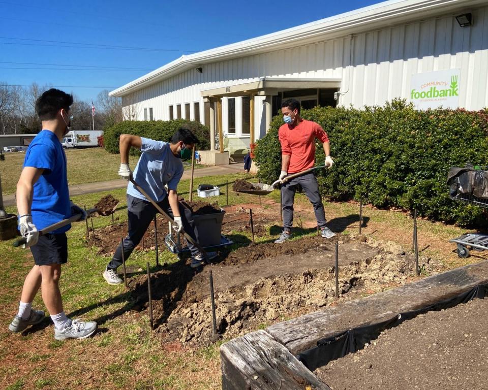 volunteers dig AL community garden