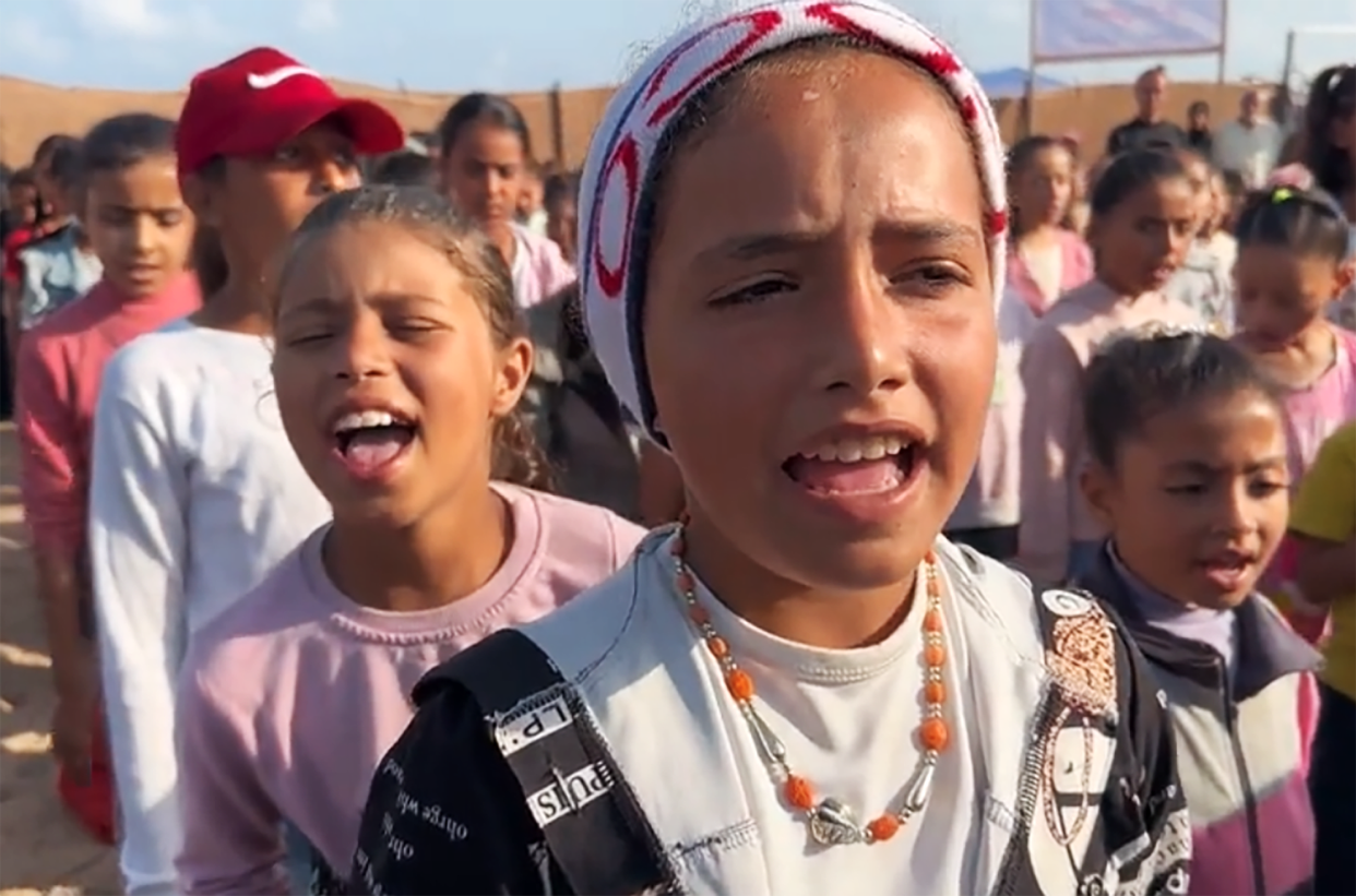 Palestinian children lined up outside the school before class, singing the national anthem, listening to the school principal. (NBC News)