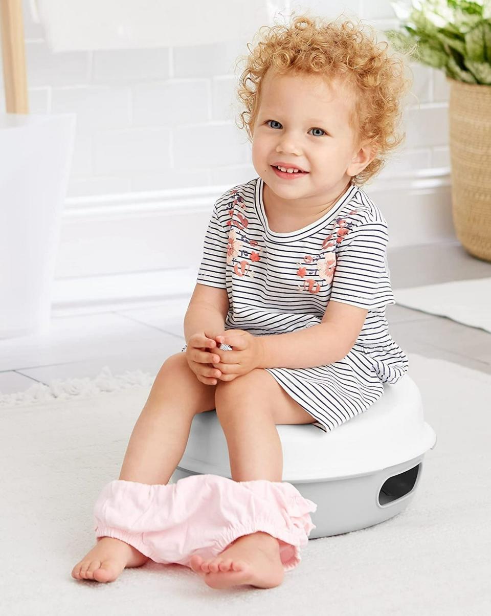 Child sits on a potty