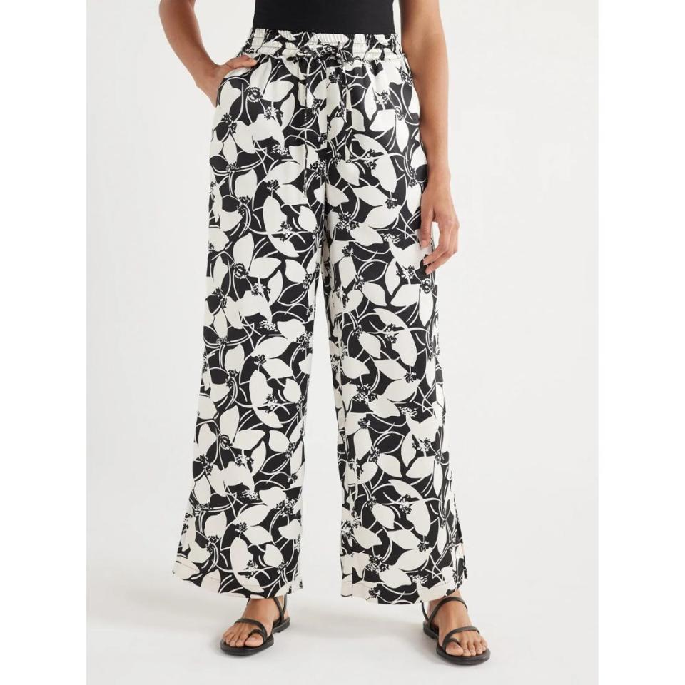 model wearing black and white floral satin pants