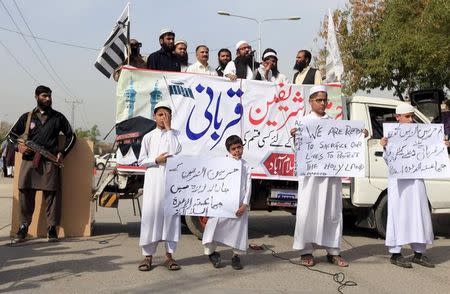 Supporters of the Jamaat-ud-Dawa Islamic organization hold placards during a demonstration in support of Saudi Arabia over its intervention in Yemen, in Islamabad March 27, 2015. REUTERS/Faisal Mahmood