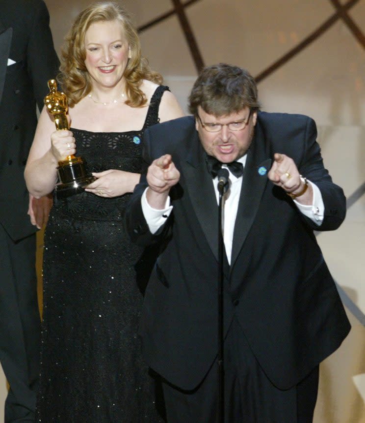 Michael Moore accepts his Oscar alongside wife and “Bowling for Columbine” producer Kathleen Glynn. (Photo: Brian Vander Brug/Getty Images)<br>