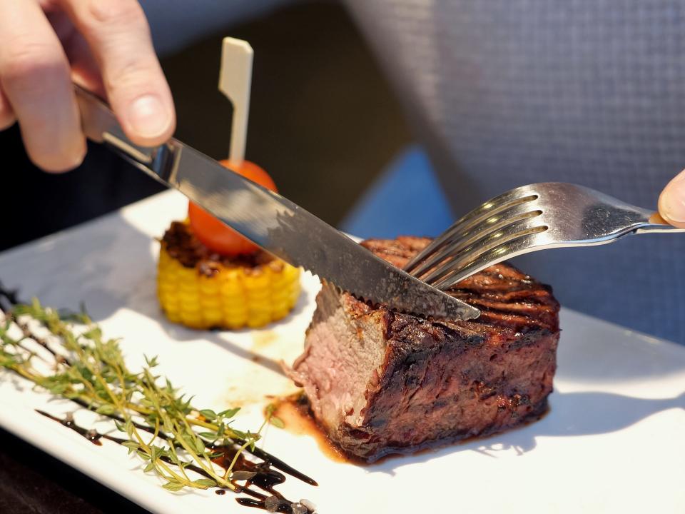 cutting eating steak meat